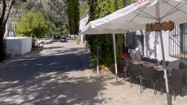 Fachada de La Tasquita del Majaceite con toldo blanco en la calle de Benamahoma